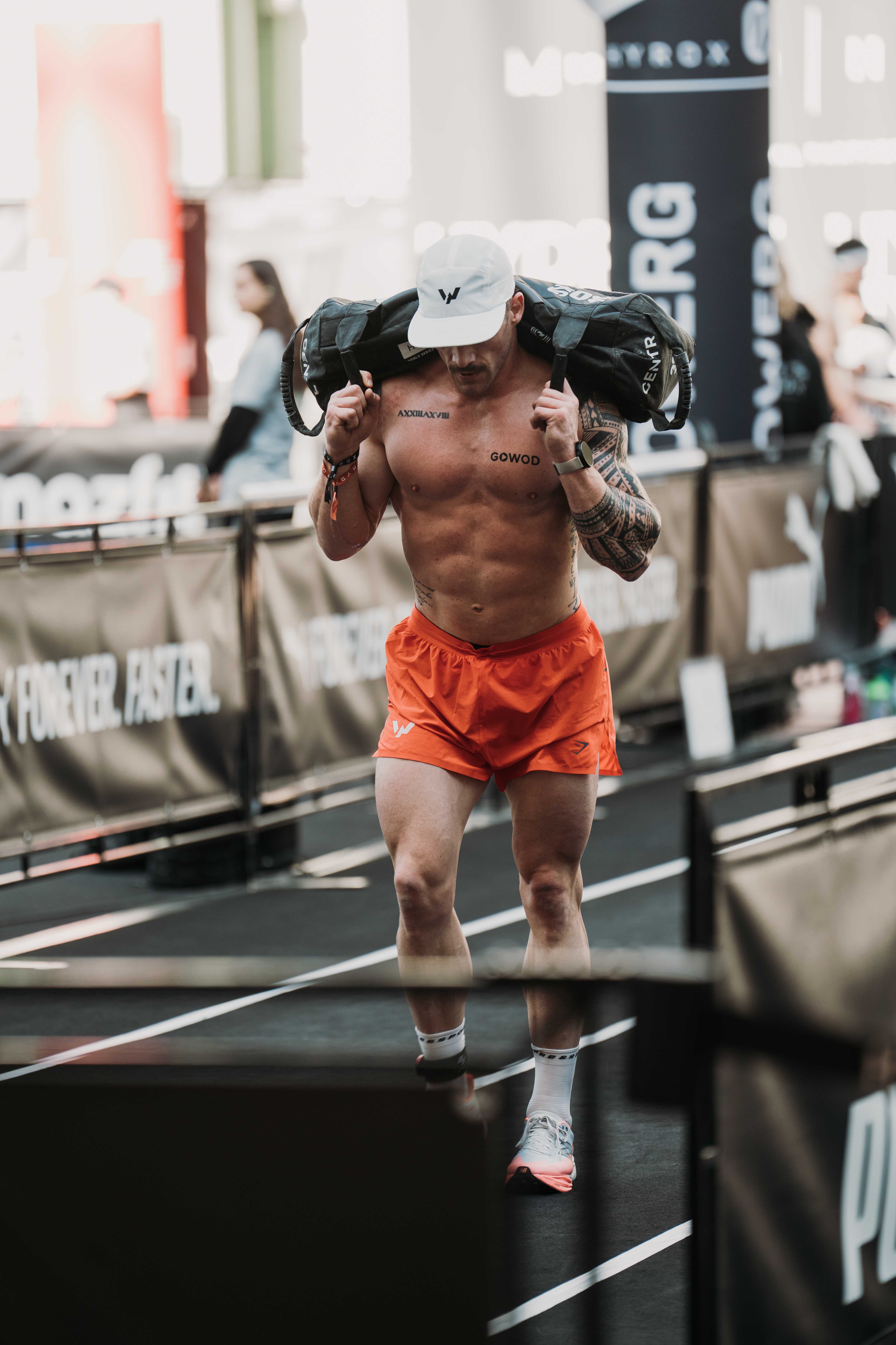 Willy Georges porte un sandbag pendant une course HYROX